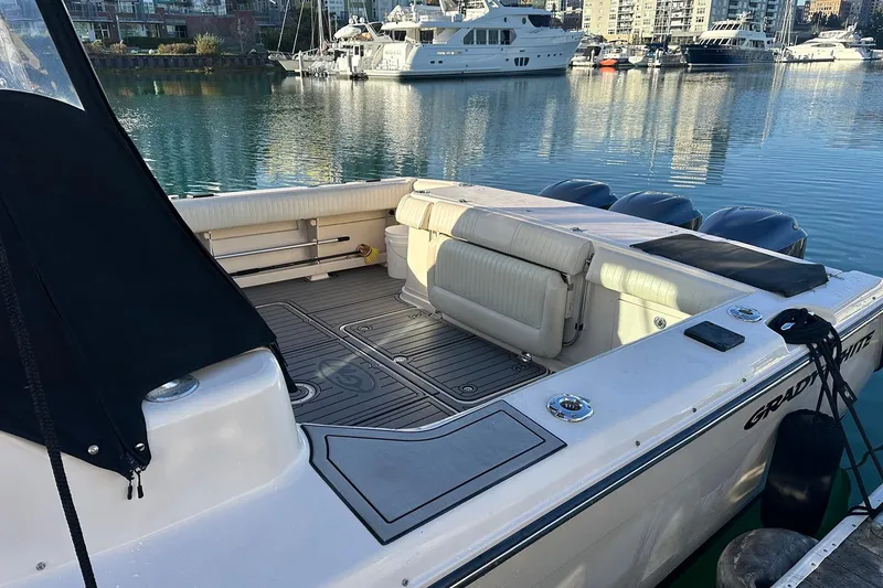 Slide: The Image of 2006 Grady-White Express 360 boat docked in a marina, showcasing spacious seating area. - 8