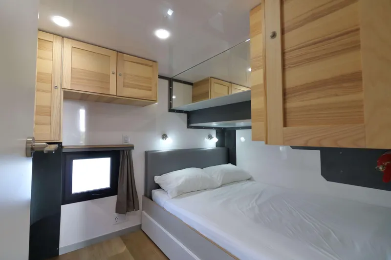 Slide: The Image of Compact bedroom interior in Navisyo Homes NV.08, 2021 model, featuring wooden cabinets and modern lighting. - 15