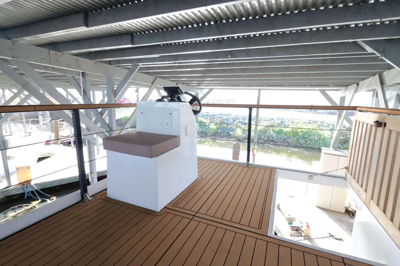 Slide: The Image of Navisyo Homes NV.08 2021 model with modern helm station on wooden deck. - 21