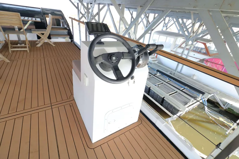 Slide: The Image of Steering console on Navisyo Homes NV.08 houseboat, 2021 model, with wooden deck. - 23