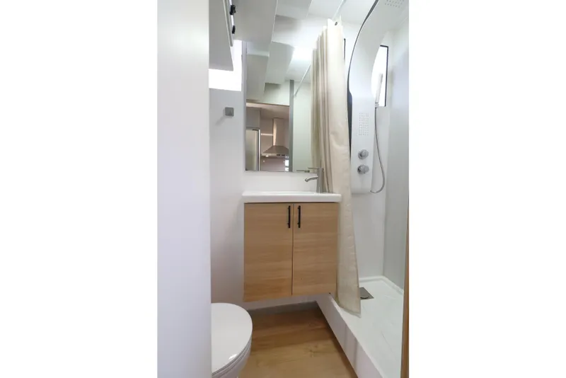 Slide: The Image of Modern bathroom in 2021 Navisyo Homes NV.08 with sleek shower and wooden cabinetry. - 26