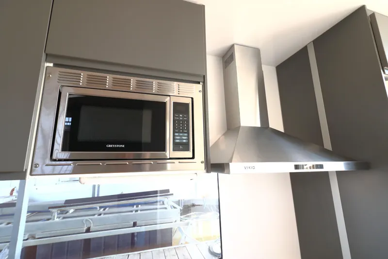 Slide: The Image of Modern kitchen with Greystone microwave and Viko range hood in Navisyo Homes NV.08, 2021 model. - 29