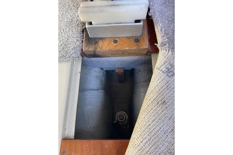 The Image of Interior view of a 1977 C&C 29 sailboat, showing underfloor compartment details. - 1