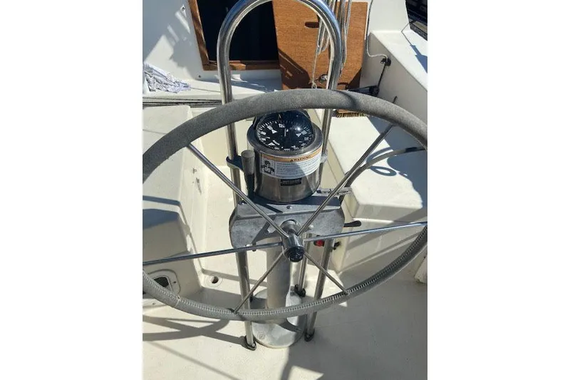 Slide: The Image of Steering wheel and compass of a 1977 C&C 29 sailboat cockpit. - 10