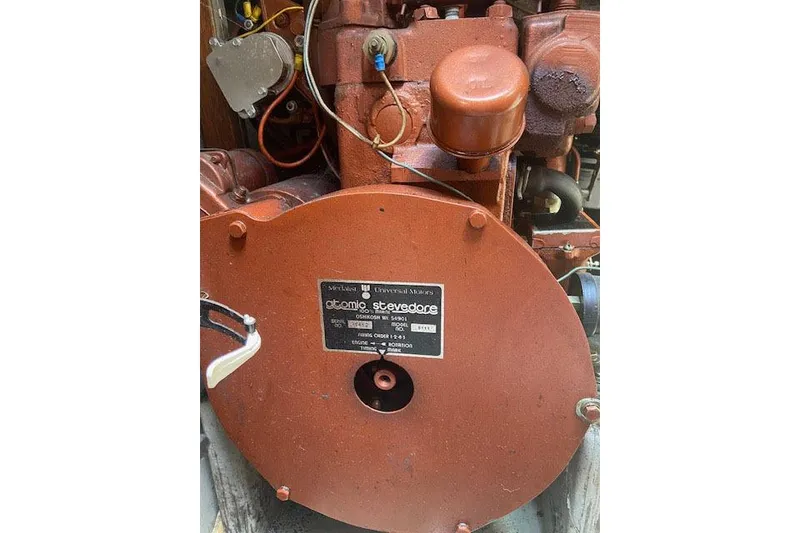 Slide: The Image of Engine of a 1977 C&C 29 sailboat, featuring an Atomic Stevedore motor. - 16