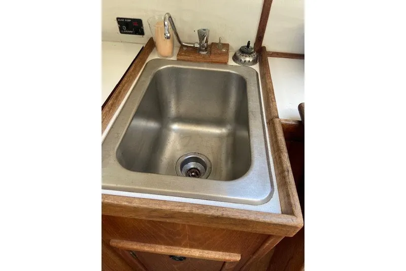 Slide: The Image of Stainless steel sink in 1977 C&C 29 yacht galley with wooden trim. - 21