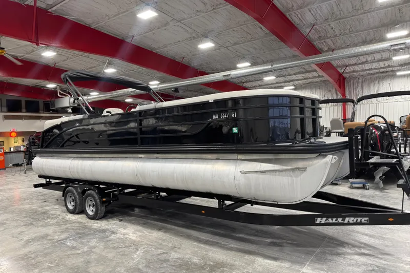 The Image of 2022 Lowe SS 270 pontoon boat on trailer in indoor showroom. - 1