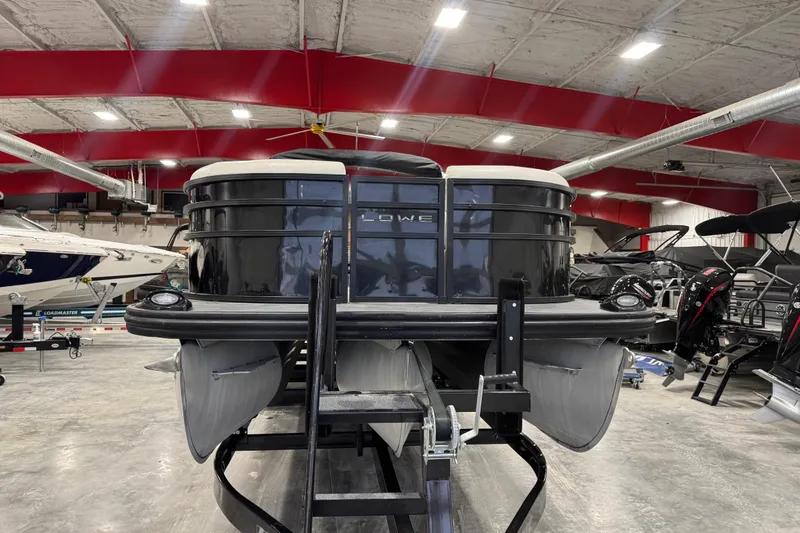 Slide: The Image of 2022 Lowe SS 270 pontoon boat in showroom with red ceiling. - 4