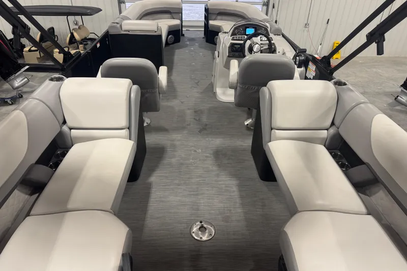 Slide: The Image of 2022 Lowe SS 270 pontoon boat interior with plush seating and modern dashboard. - 6