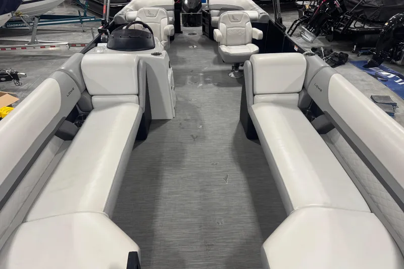 Slide: The Image of 2022 Lowe SS 270 pontoon boat interior with spacious seating and modern design. - 8