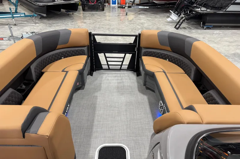Slide: The Image of Luxurious interior of 2026 Sylvan L-5 Platinum pontoon boat with tan seating. - 12