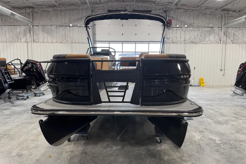 Slide: The Image of 2026 Sylvan L-5 Platinum pontoon boat in a showroom, rear view. - 5