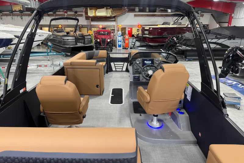 Slide: The Image of 2026 Sylvan L-5 Platinum boat interior with tan seating and modern dashboard. - 9