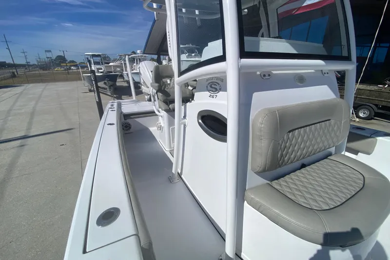 Slide: The Image of 2021 Sportsman Masters 267 Bay Boat with cushioned seating and sleek design. - 14