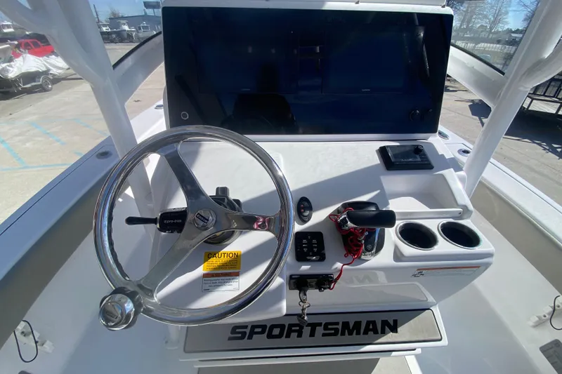 Slide: The Image of 2021 Sportsman Masters 267 Bay Boat helm with steering wheel and controls. - 19