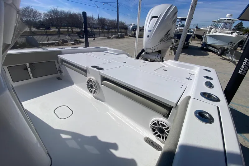 Slide: The Image of 2021 Sportsman Masters 267 Bay Boat interior with Yamaha engine, rod holders, and speakers. - 20