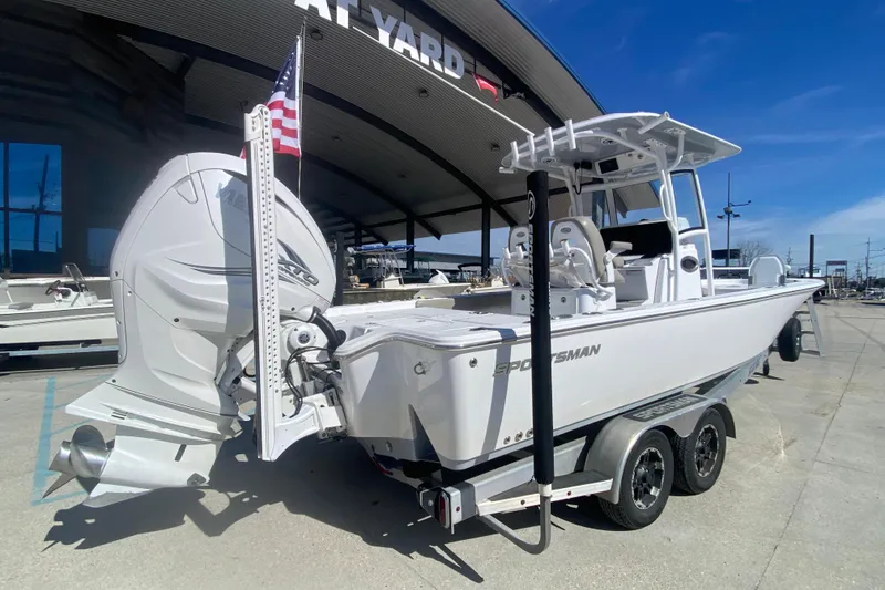 Slide: The Image of 2021 Sportsman Masters 267 Bay Boat on trailer, displayed outdoors with American flag. - 4