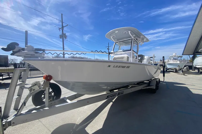 Slide: The Image of 2021 Sportsman Masters 267 Bay Boat on trailer under clear blue sky. - 8