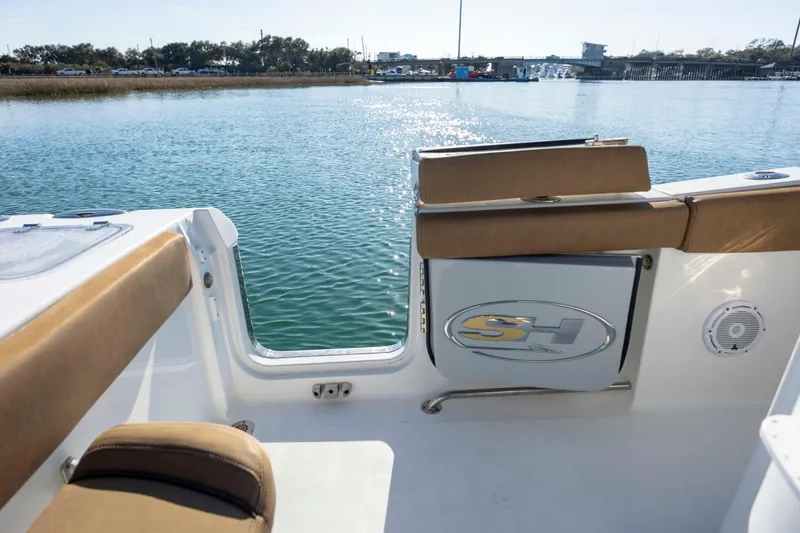 Slide: The Image of 2022 Sea Hunt Gamefish 25 boat interior with seating, overlooking calm waters. - 10
