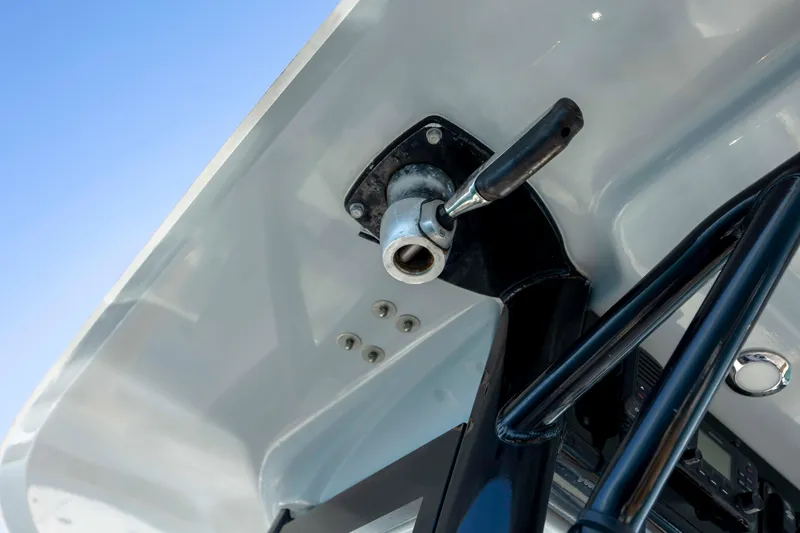 Slide: The Image of Close-up of 2022 Sea Hunt Gamefish 25 boat's steering mechanism under a clear blue sky. - 13