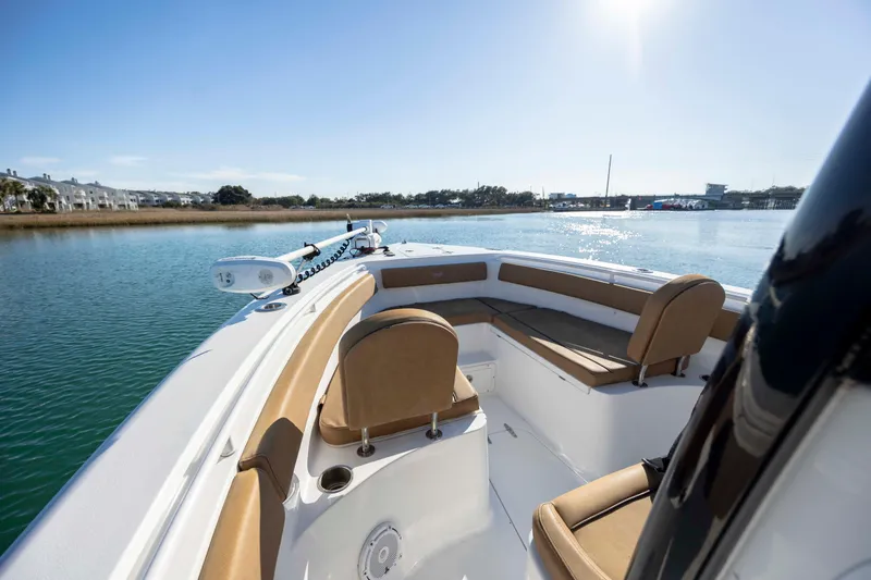 Slide: The Image of 2022 Sea Hunt Gamefish 25 boat with tan seating on calm water. - 15