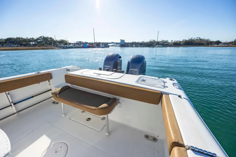 Slide: The Image of 2022 Sea Hunt Gamefish 25 boat with twin engines on a sunny day. - 6