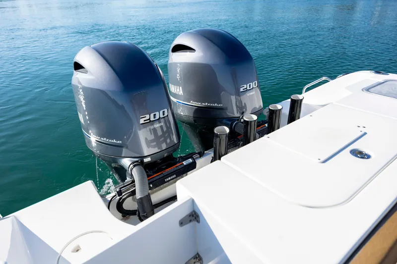 Slide: The Image of Twin Yamaha 200 engines on a 2022 Sea Hunt Gamefish 25 boat in clear water. - 7