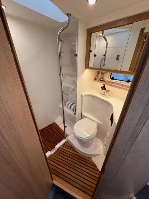 Slide: The Image of 2023 Nimbus 405 Coupé yacht on calm water, showcasing sleek design and modern features. - 13