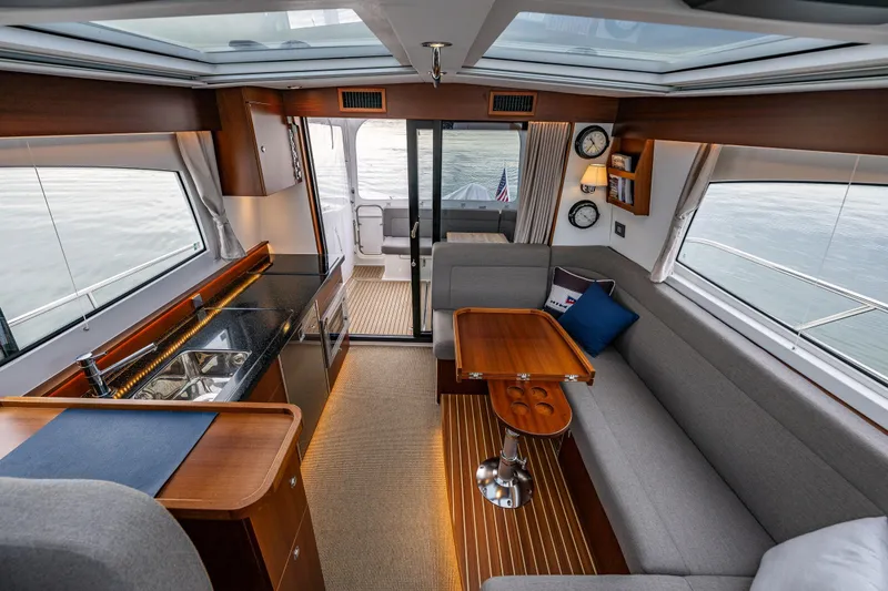 Slide: The Image of Luxurious interior of 2023 Nimbus 405 Coupé yacht with modern kitchen and seating area. - 23
