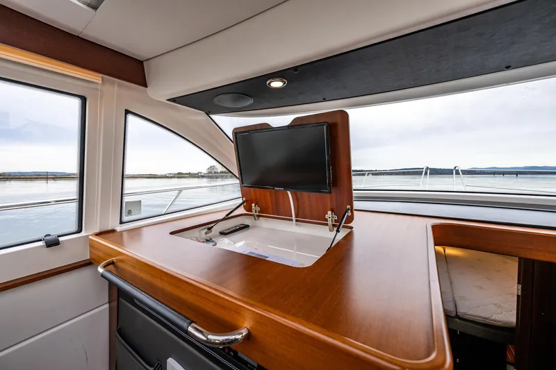 Slide: The Image of 2023 Nimbus 405 Coupé interior with retractable TV and scenic water view. - 27