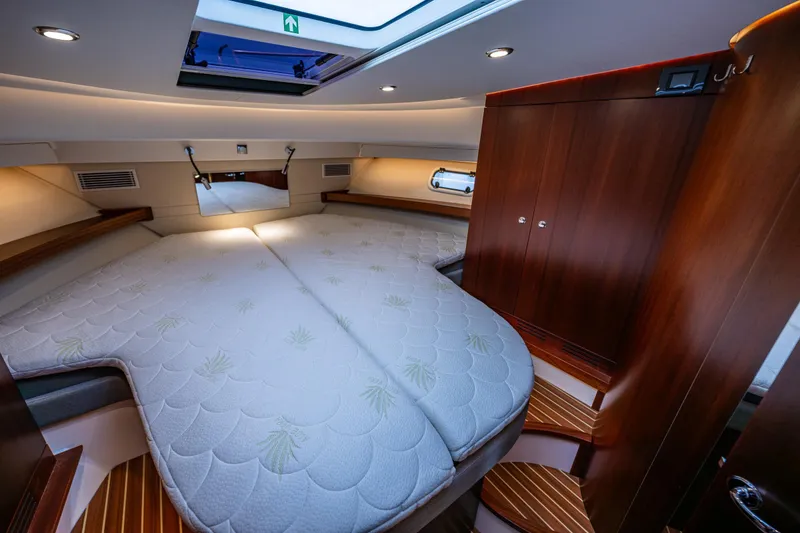 Slide: The Image of Luxurious interior cabin of 2023 Nimbus 405 Coupé yacht with elegant wood finishes. - 34
