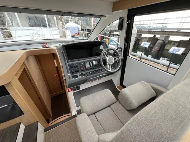 Slide: The Image of 2023 Nimbus 405 Coupé yacht named "Crazy Love" cruising in a scenic harbor. - 10
