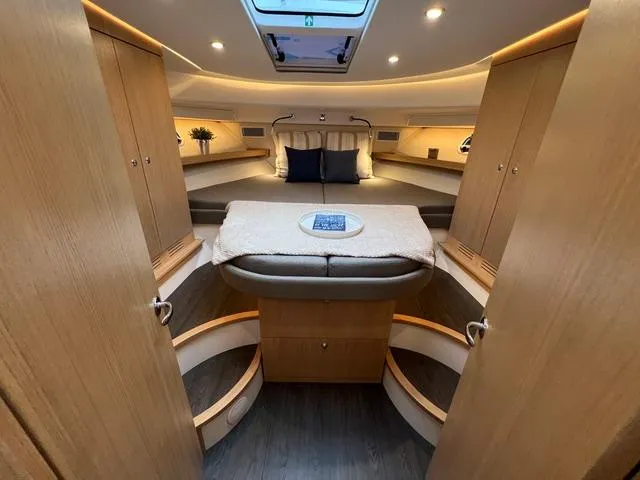 Slide: The Image of 2023 Nimbus 405 Coupé yacht docked on calm water, showcasing sleek design and modern features. - 12