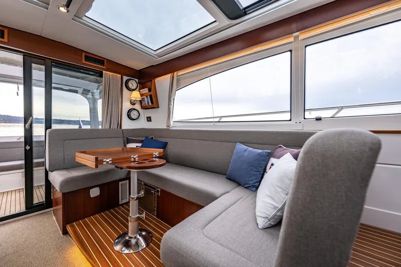 Slide: The Image of Luxurious interior of 2023 Nimbus 405 Coupé yacht with elegant seating and panoramic windows. - 20