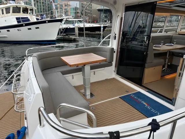 Slide: The Image of Nimbus 405 Coupé 2023 on calm waters near rocky shoreline. - 4