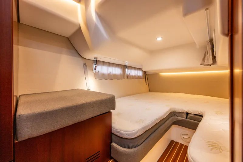 Slide: The Image of Luxurious cabin interior of 2023 Nimbus 405 Coupé with cozy bedding and ambient lighting. - 40