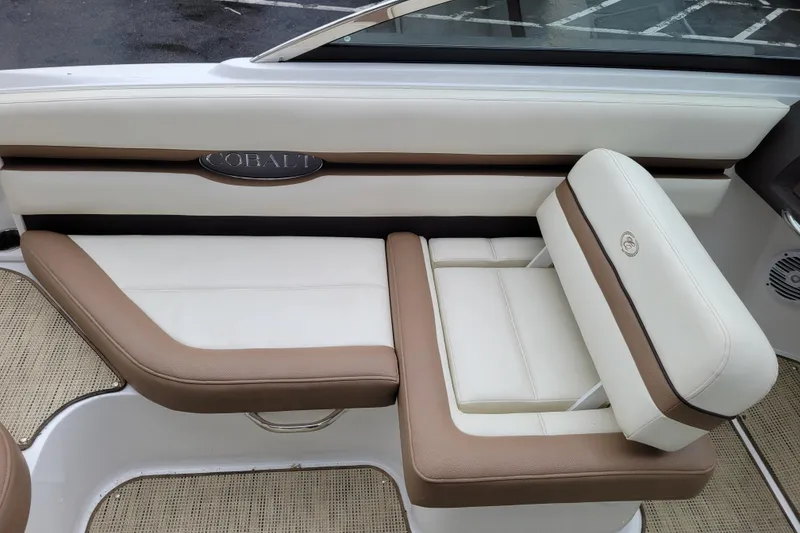 Slide: The Image of 2016 Cobalt CS3 boat interior with beige and white seating. - 10