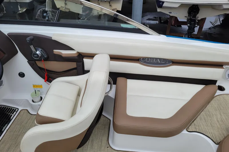 Slide: The Image of Interior of a 2016 Cobalt CS3 boat with beige and brown seating. - 11