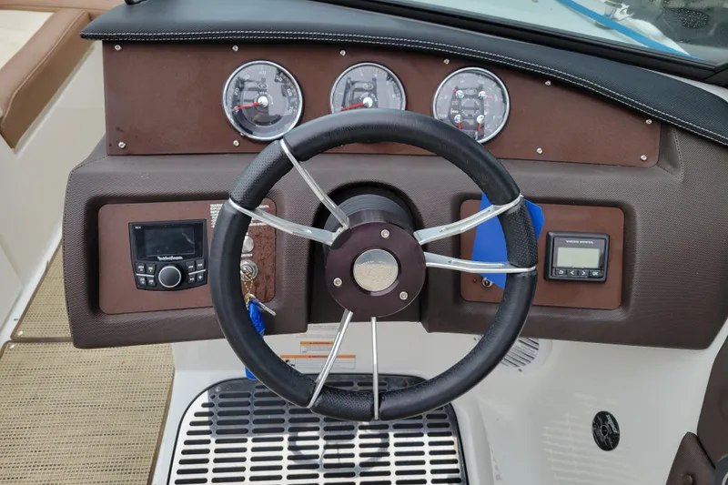 Slide: The Image of Steering wheel and dashboard of a 2016 Cobalt CS3 boat with gauges and controls. - 12