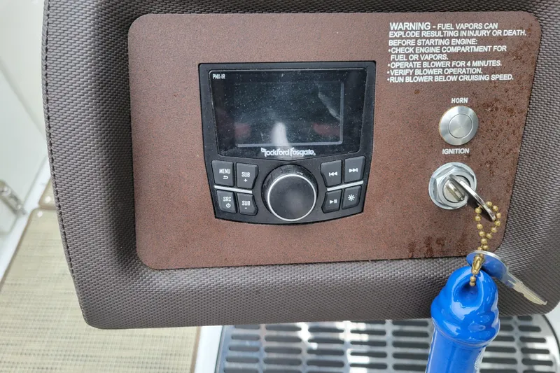 Slide: The Image of Control panel of a 2016 Cobalt CS3 boat with ignition and audio system. - 13