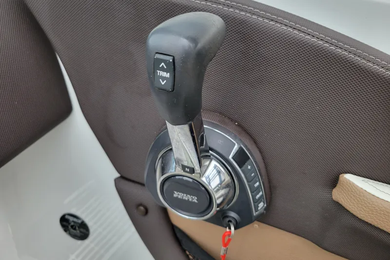 Slide: The Image of Throttle control lever on 2016 Cobalt CS3 boat, featuring trim adjustment buttons. - 17