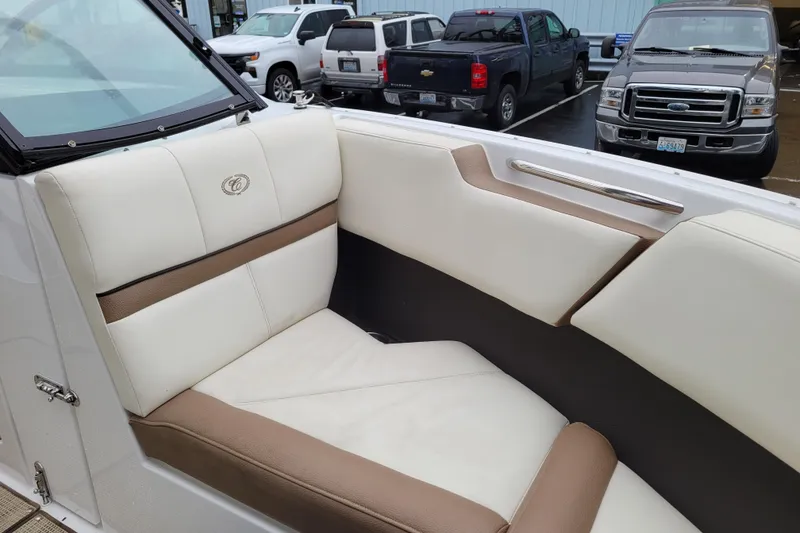 Slide: The Image of 2016 Cobalt CS3 boat interior with beige and brown seating, parked cars in background. - 20