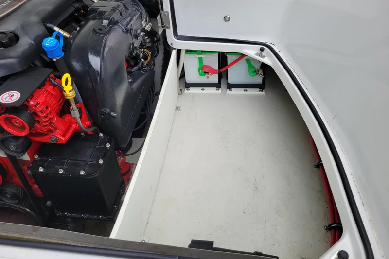 Slide: The Image of Engine compartment of a 2016 Cobalt CS3 boat, featuring visible engine and battery setup. - 25