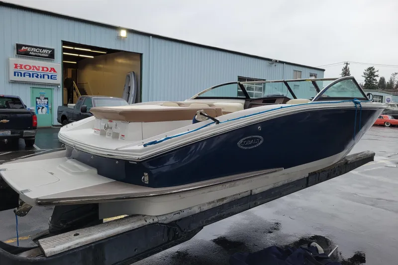 Slide: The Image of 2016 Cobalt CS3 boat on trailer near Honda Marine service center. - 3