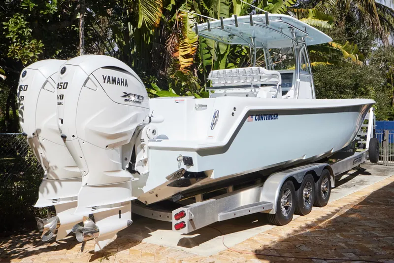 Slide: The Image of 2024 Contender 35 ST boat with dual Yamaha 450 V8 engines on a trailer. - 1