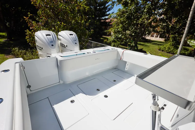 Slide: The Image of 2024 Contender 35 ST boat with dual Yamaha V8 engines, spacious deck, and sleek design. - 12