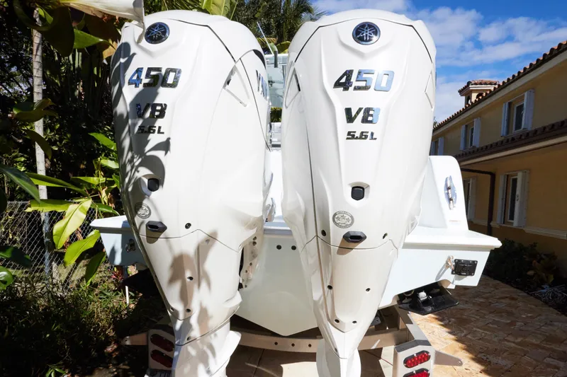 Slide: The Image of 2024 Contender 35 ST boat with twin 450 V8 5.6L engines, parked outdoors. - 6