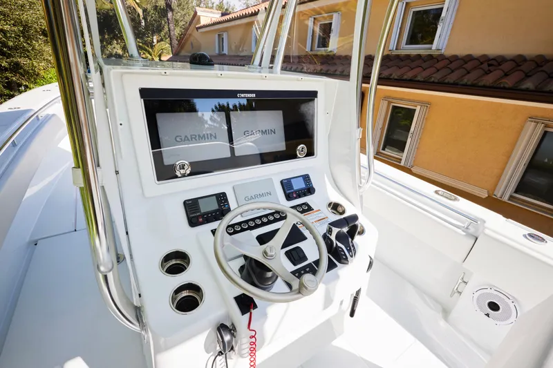 Slide: The Image of 2024 Contender 35 ST boat console with Garmin navigation system and steering wheel. - 8