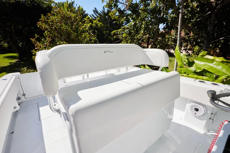Slide: The Image of 2024 Contender 35 ST boat interior with white seating, surrounded by lush greenery. - 9