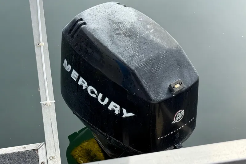 Slide: The Image of Mercury outboard motor on 2006 Myacht 4313, docked on calm water. - 17